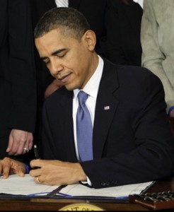 Obama signs the health care bill